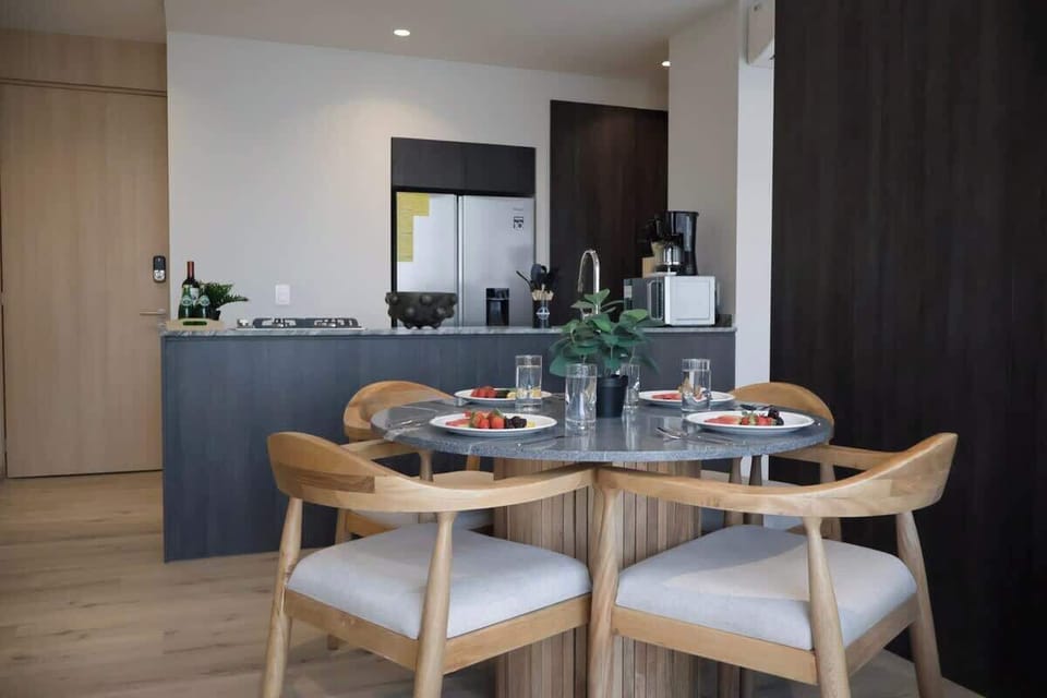 Gather around the dining table set for four, just steps from the open kitchen