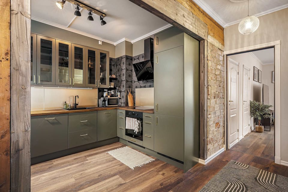 A fully equipped kitchen with updated appliances and unique wood accents.