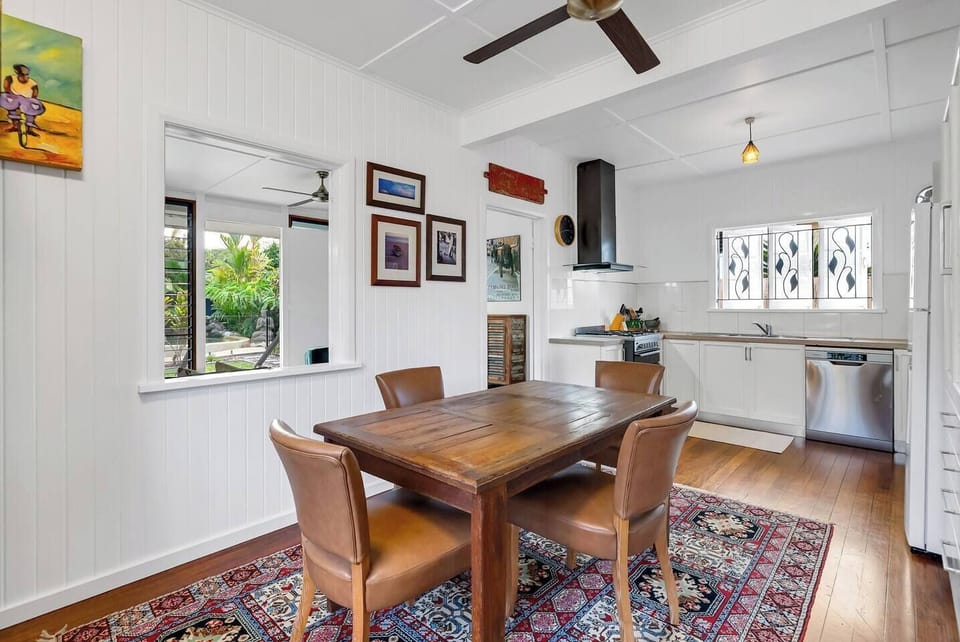 Share a meal or plan your day in the inviting dining area, where a Persian-style rug, timber furniture and bold artwork add soul and warmth.