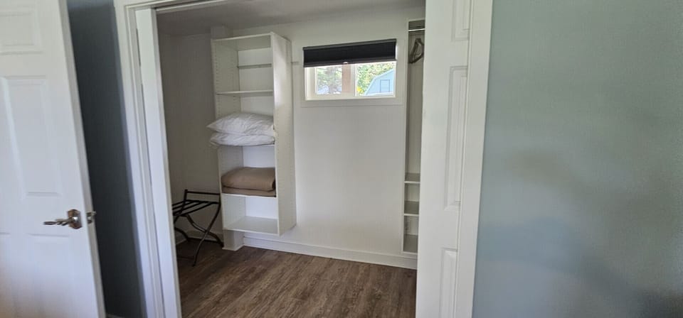 Spacious closet area with built-in shelving and convenient storage for an organized stay.