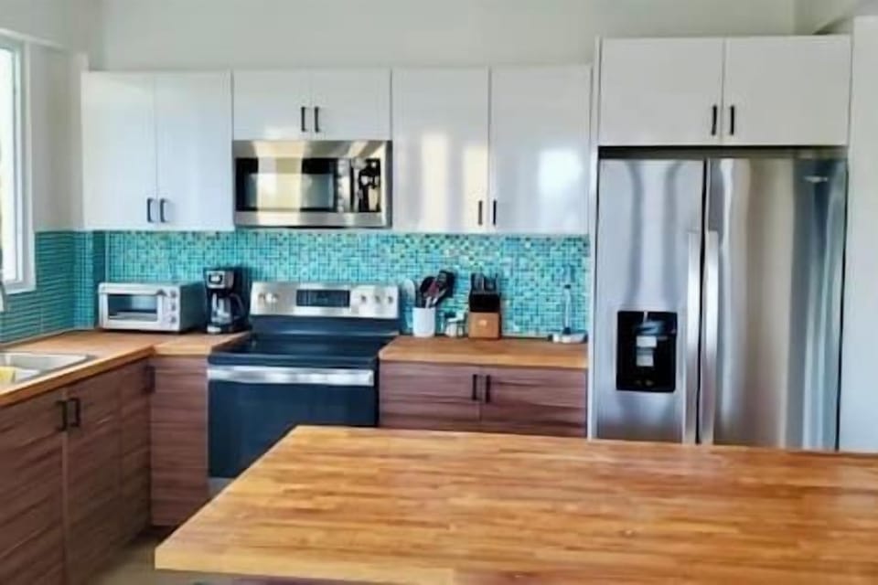 Kitchen close up:  Fully equipped with ice maker, oven, air fryer, coffee maker, microwave and cooking items.