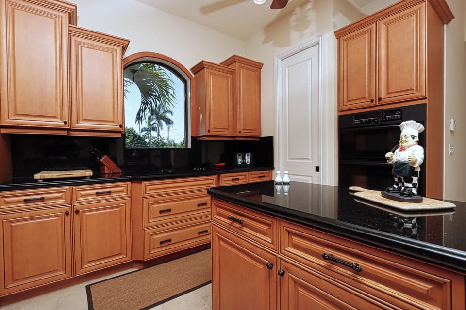A dream for any cook — this kitchen boasts lots of cabinets, keeping countertops clutter-free and everything neatly tucked away