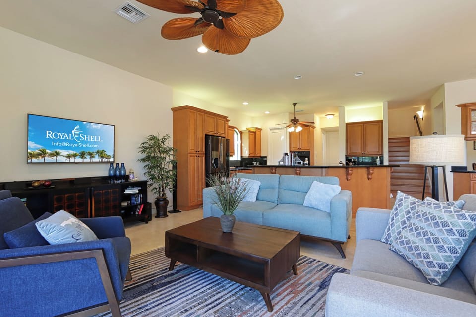 This open-concept layout blends the kitchen and living room seamlessly, ideal for group gatherings and movie nights