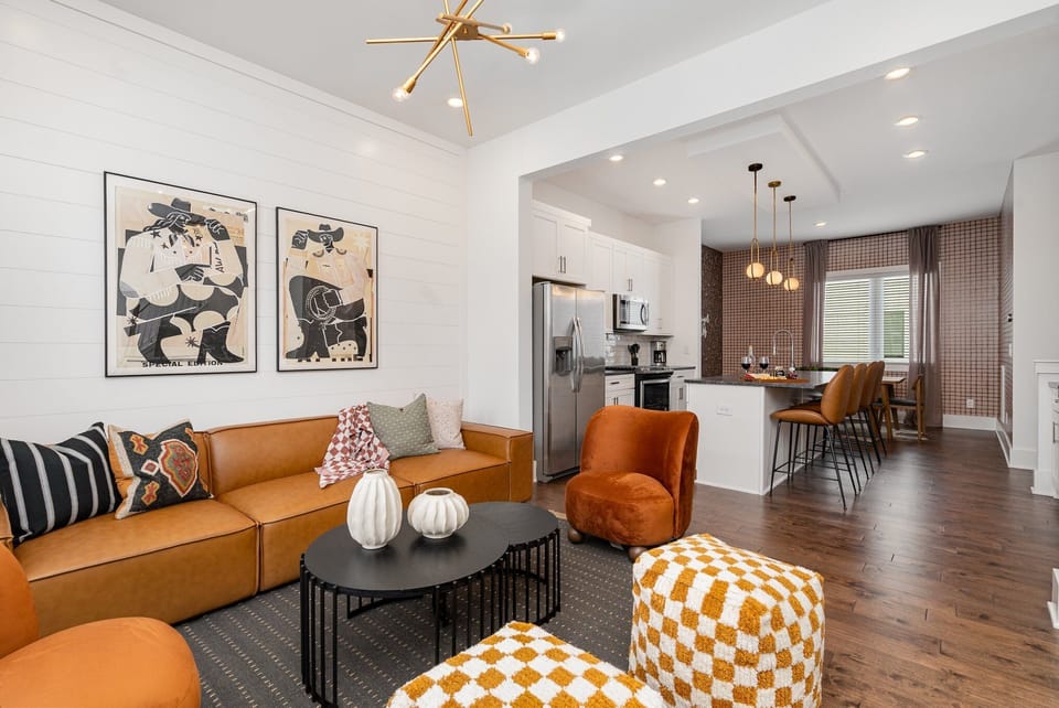 Bright open floor living space featuring designer furnishings and a smart flat-screen TV. (2nd Floor)