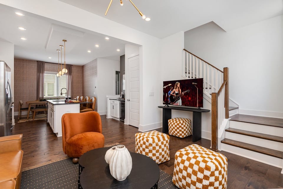 Bright open floor living space featuring designer furnishings and a smart flat-screen TV. (2nd Floor)