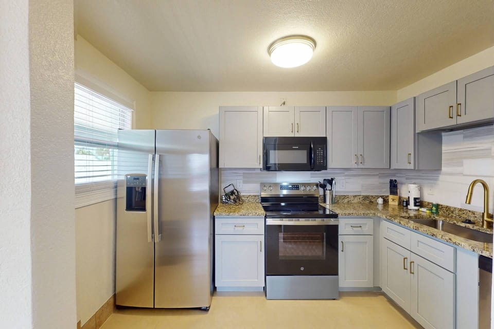 Two full kitchens with granite countertops, stainless steel appliances, and everything needed to cook and dine in
