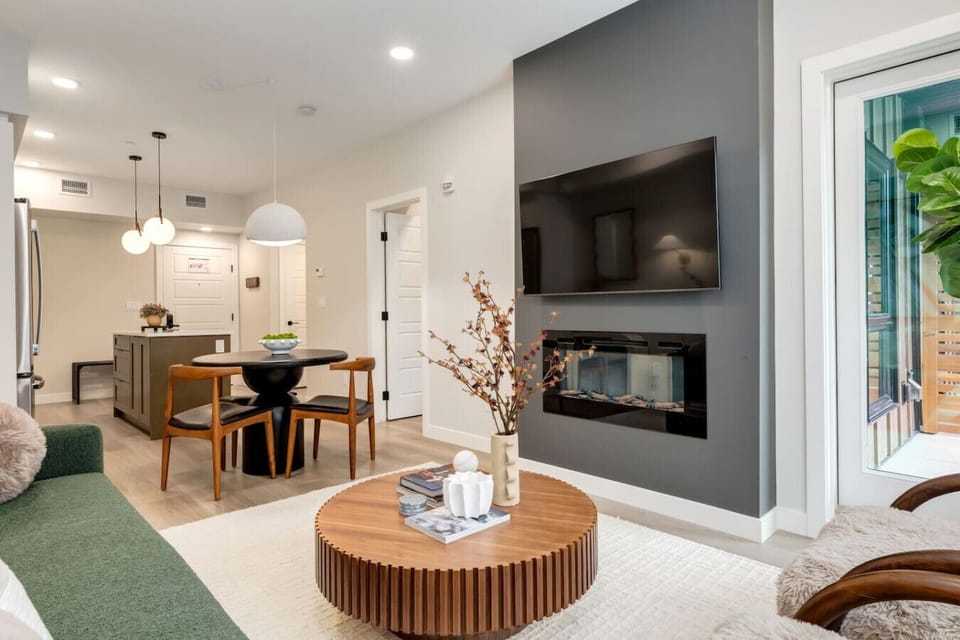 Living area with a fireplace, TV and dining area,
