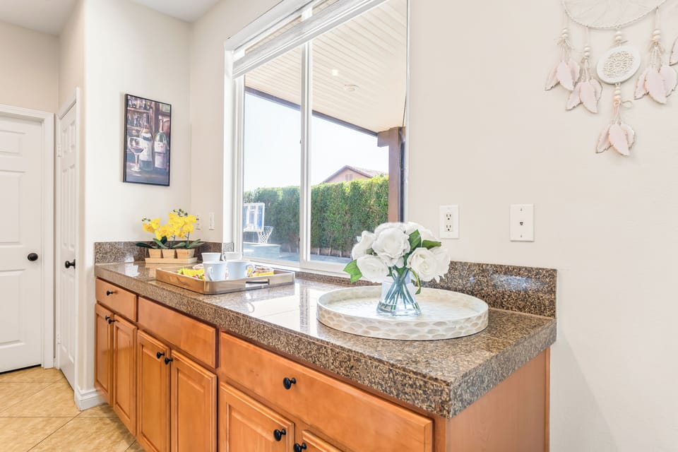 Granite countertops and light wood cabinets.