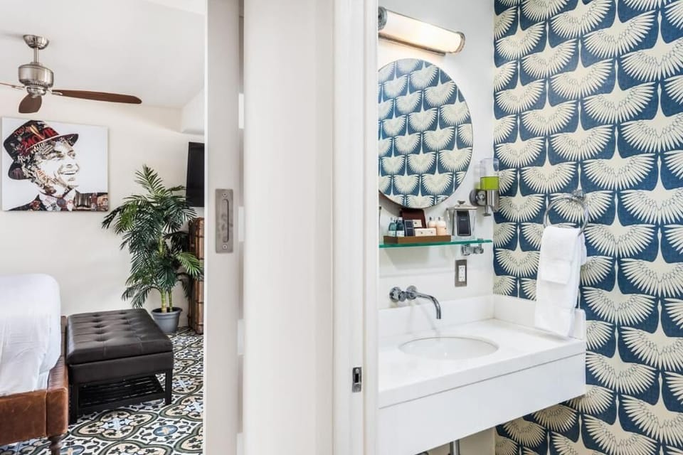Refresh quickly in the chic powder room with bold designer wallpaper.