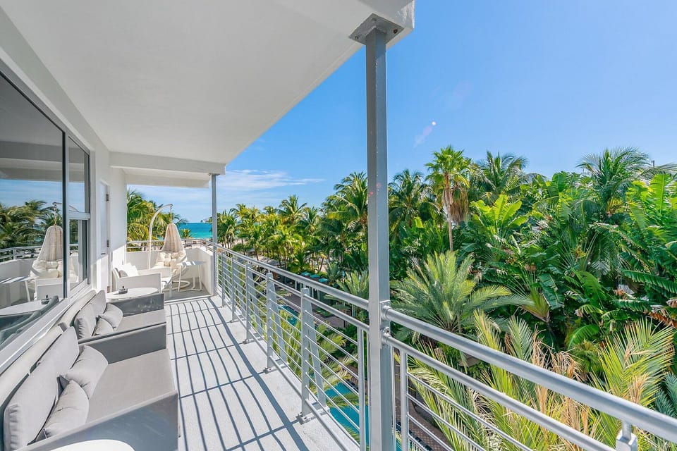 Lounge outdoors and breathe in breezy oceanfront palm views.