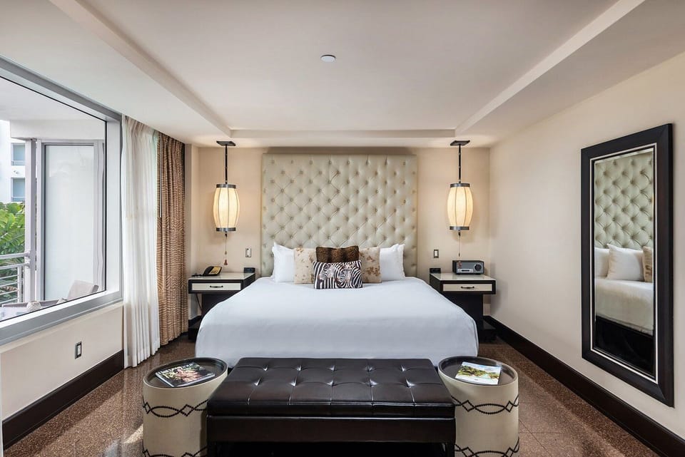 Sink into crisp linens and a softly tufted headboard.
