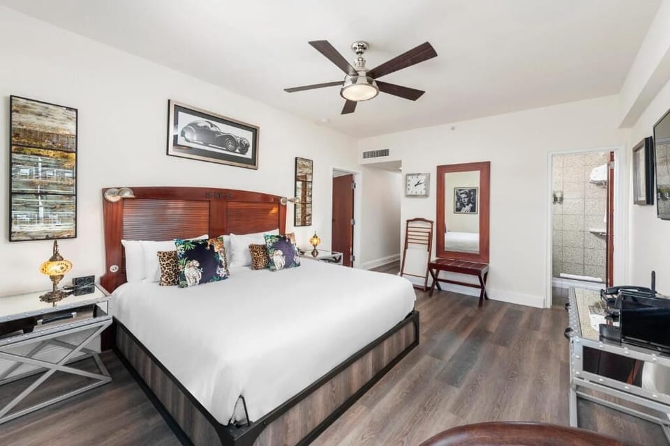 Unwind in crisp linens beneath warm lighting and artful décor.