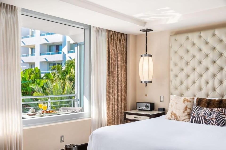 Soak in the bright window view from crisp linens.