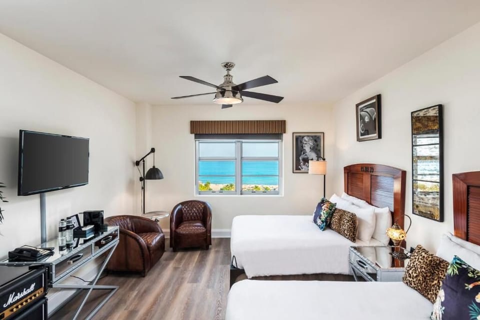 Step into a bright coastal bedroom with sweeping sea views.