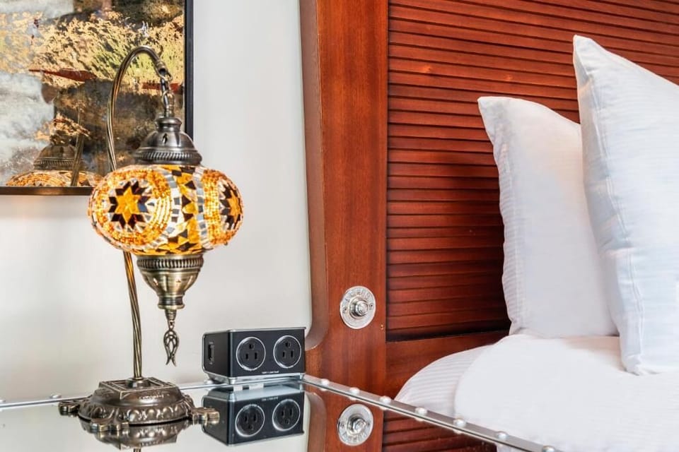 Savor cozy bedside glow with boutique details and luxe pillows.