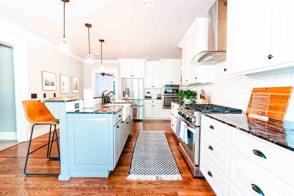 Gourmet Kitchen, fully remodeled and equipped with gas range, stone countertops and plenty of seating for an extended family dinner.