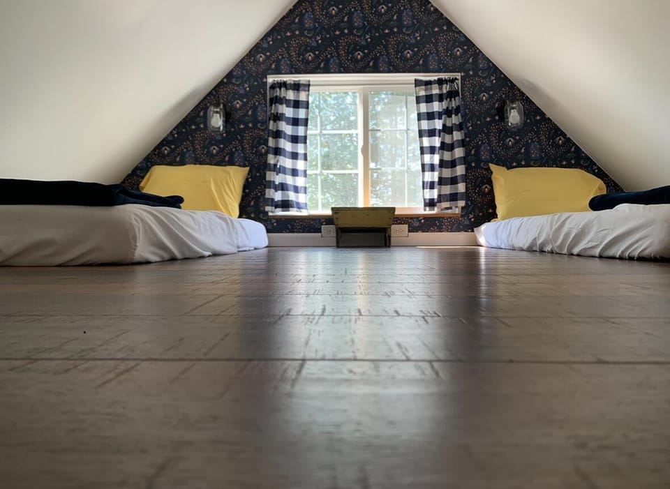 Roomy sleeping loft has 2, twin xl mattresses