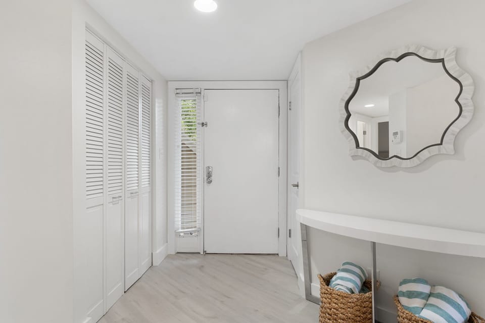 This bright, coastal entryway welcomes you with soft tones, beachy accents, and a clean, airy feel.