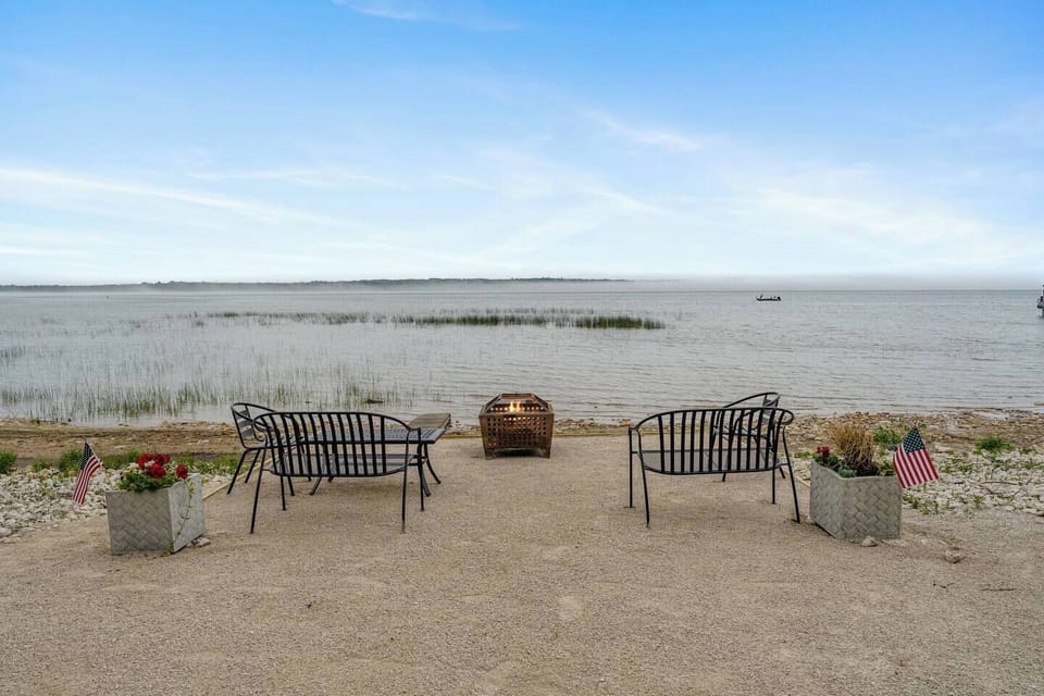 Fireside seating with lake views—unwind under the stars on North Bay at our Door County retreat.