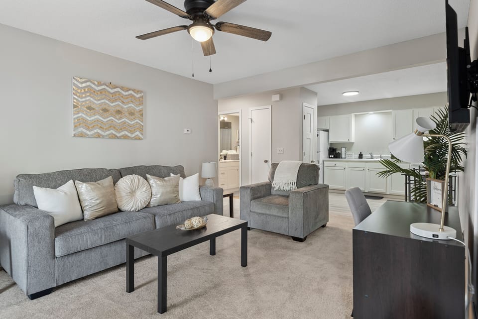 Bright, modern living space with comfy seating and a workspace for productivity.