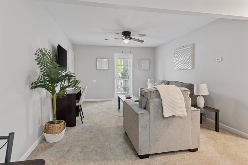 Living Room Retreat: Enjoy bright spaces, modern decor, and easy access to your private patio!