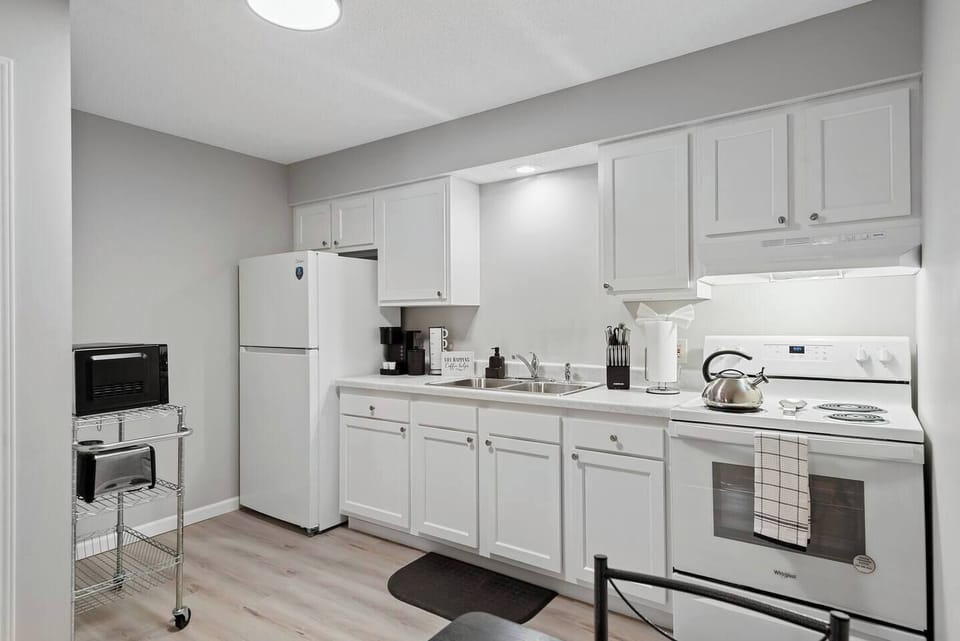Kitchen: Bright and functional space with modern appliances and inviting dining for two! A small space packed with all the essentials you need - stove/oven, full fridge, Keurig, blender, toaster and microwave!