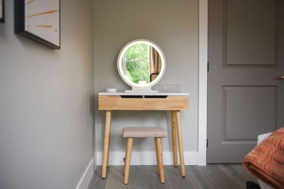 Pamper yourself at this beautiful vanity with an illuminated mirror and stool.