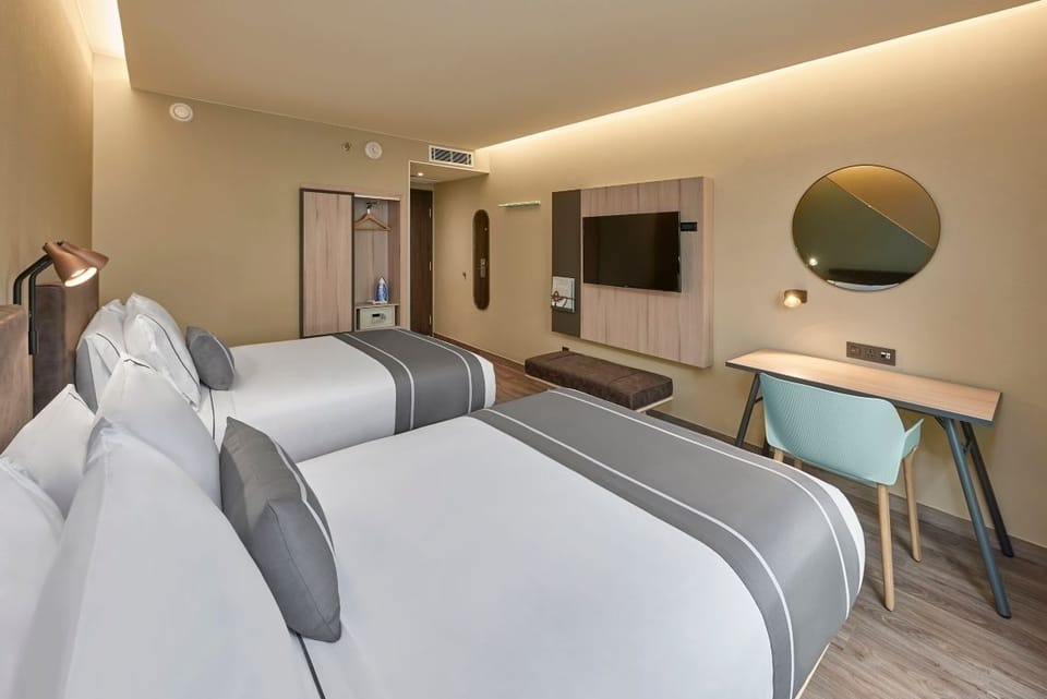 Recharge in crisp linens with a dedicated desk workspace.