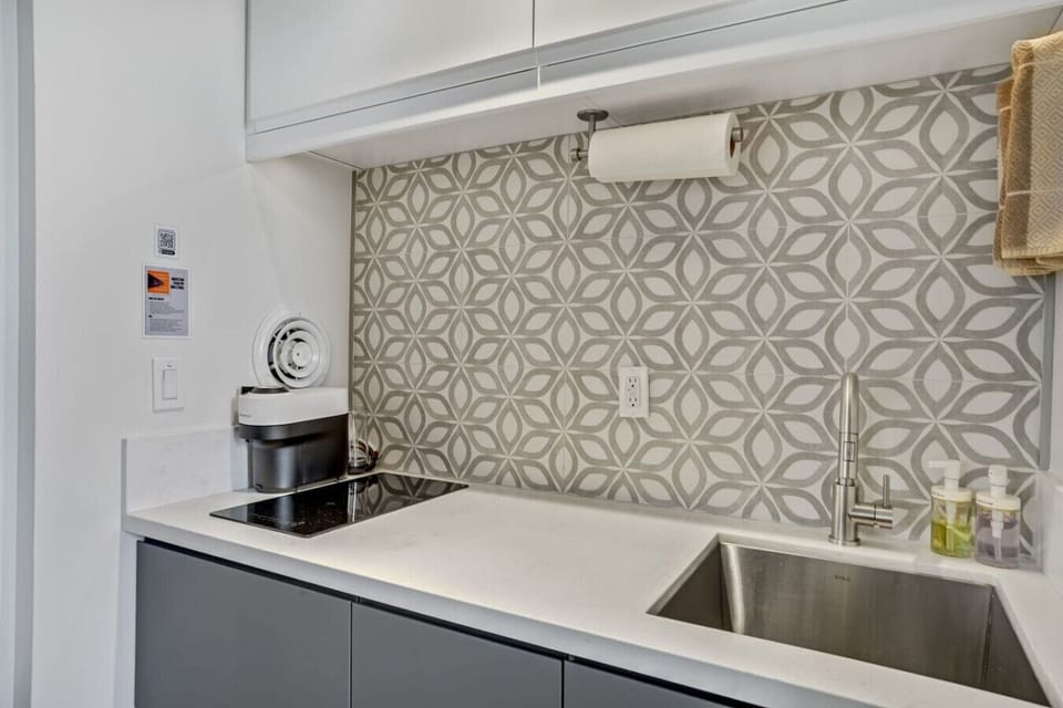 A coffee maker, induction cooker, side exhaust, and a sink
