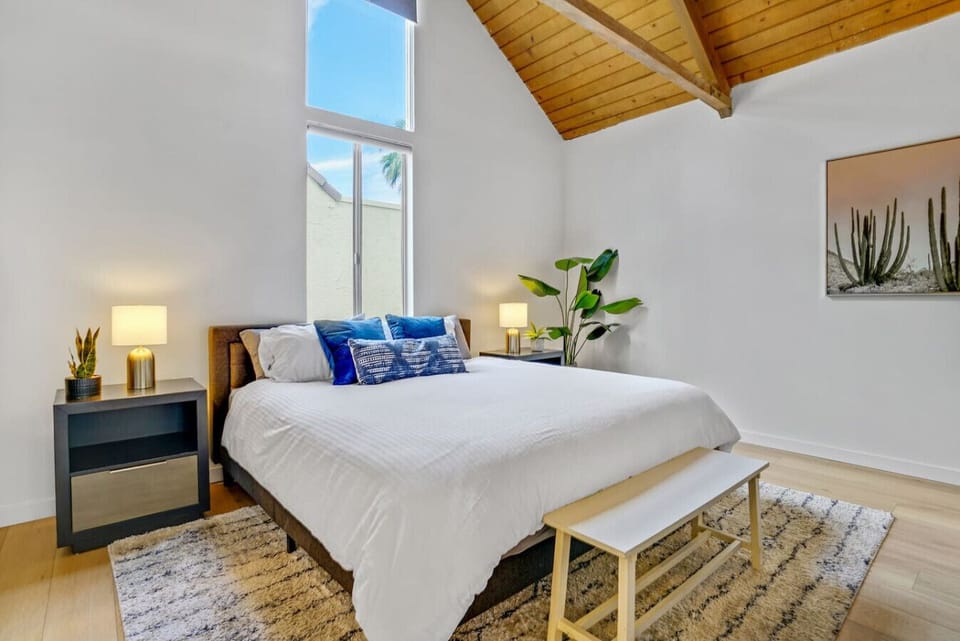 King size bed with a view, an end-of-bed bench and a roll down blinds