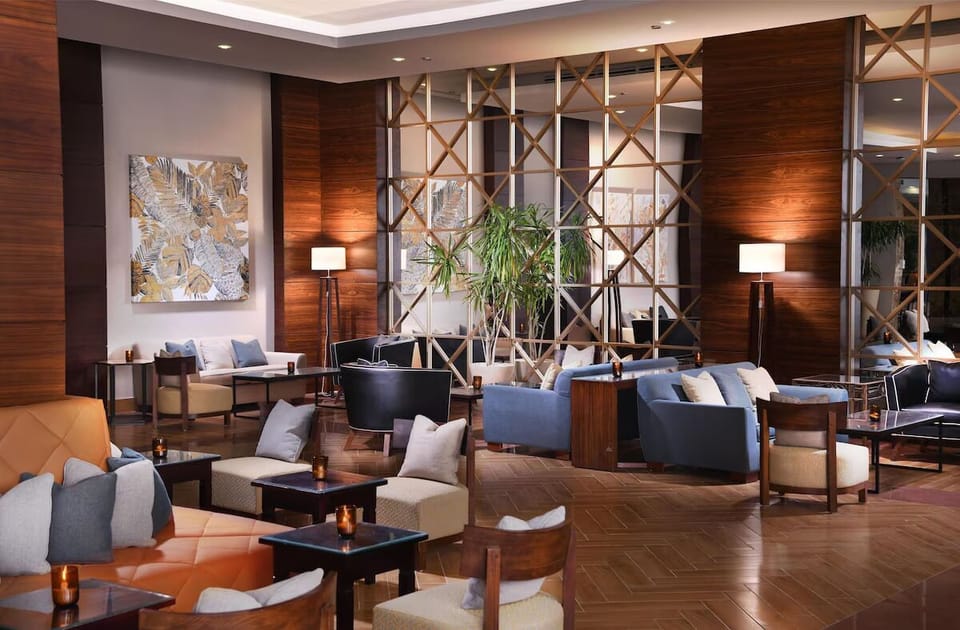 Unwind on plush seating surrounded by warm, elegant lighting.