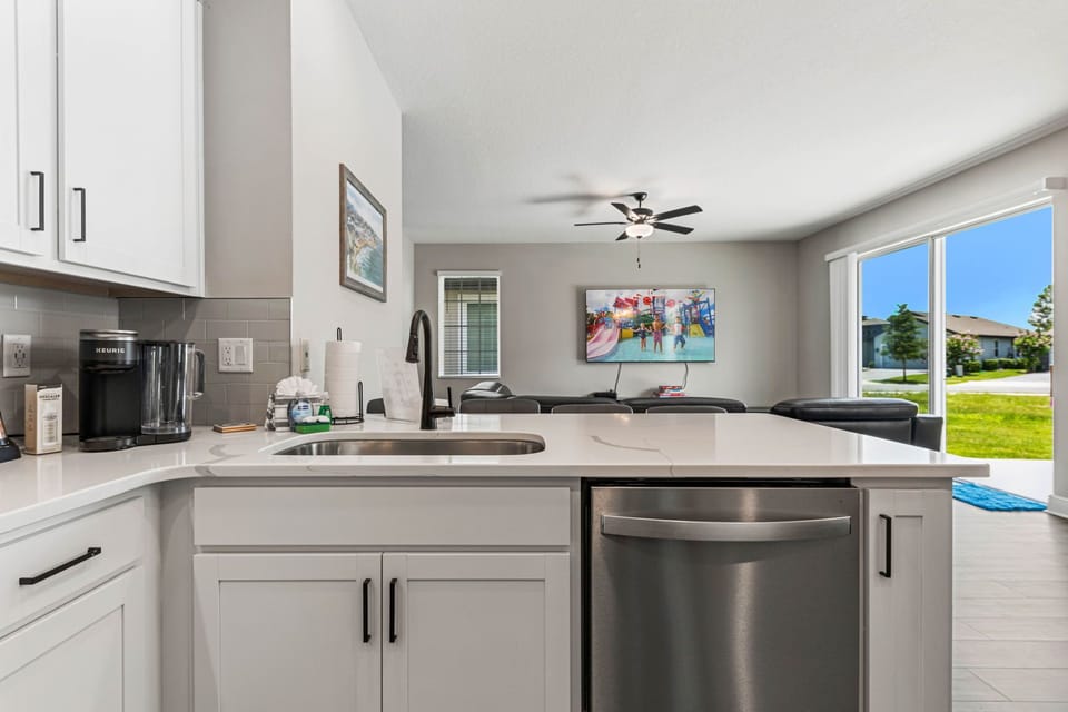 Modern kitchen with island seating and bright natural light, perfect for entertaining.