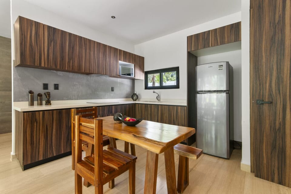 Stylish kitchen with fridge and dining area for long stays.