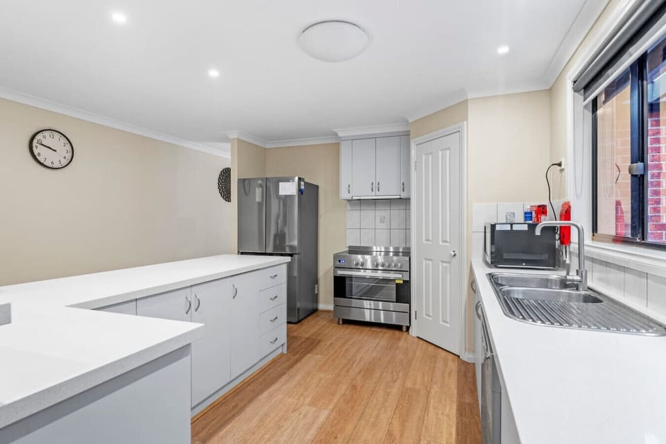 Spacious kitchen and dining area with large oven,with cook top  perfect for family meals and entertaining.Enjoy the comfort of air conditioning, a TV for entertainment, and plenty of room to relax together in this welcoming family space.