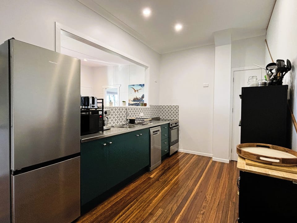 Well-equipped kitchen with stainless appliances including dishwasher