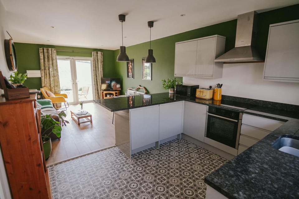 Beautiful modern kitchen with coffee machine and integrated fridge and freezer. 