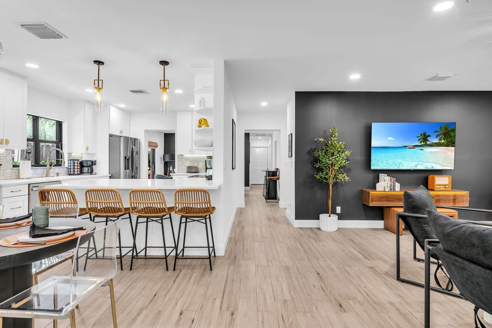 Stylish open-concept living with a 65" Smart TV, rattan bar seating, and designer finishes. Enjoy your favorite shows or playlists on the retro AM/FM Bluetooth radio in this bright, modern space.