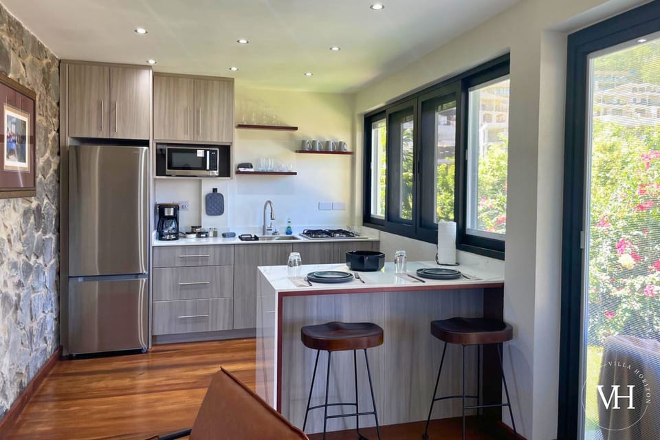 Bougainvillea Studio - Full kitchen with fridge, stove, sink, cooking essentials, and coffee.