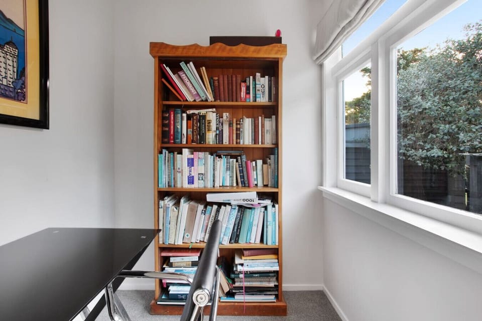 The bookcase is filled with interesting books that you can read while you are staying.