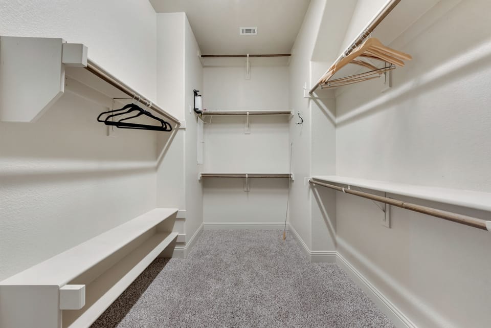 The primary suite will spoil you with this spacious in suite closets with hangers.