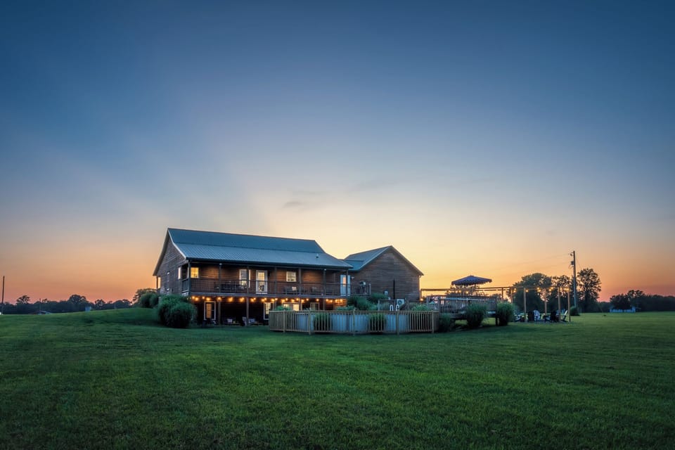 Your cabin in the country glowing warm against a Kentucky sunset on 6 peaceful acres. 🌅 This is what escape looks like.