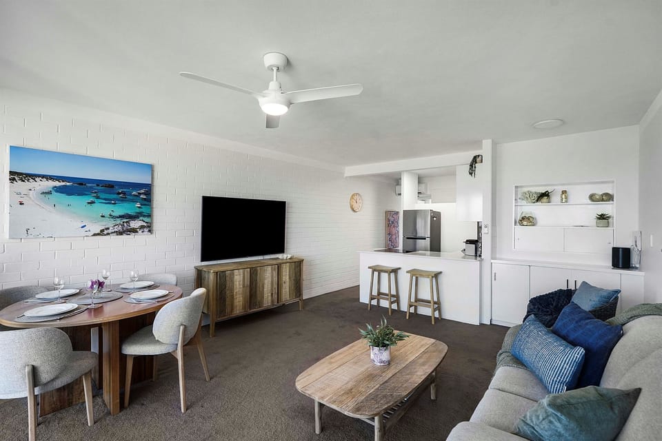 Coastal charm meets comfort—featuring a dining nook, modern kitchen, and plush seating for your entire group.