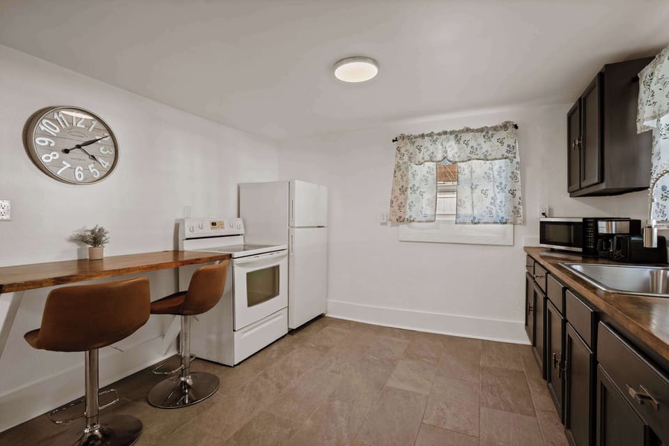 Open kitchen & dining area w/ bar seating and bright, airy layout