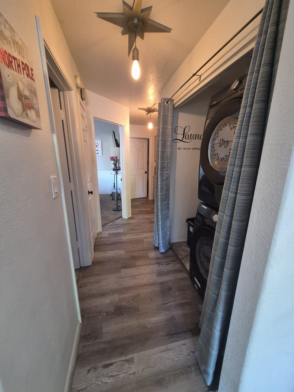 Downstairs hall with laundry area, bathroom and two bedrooms