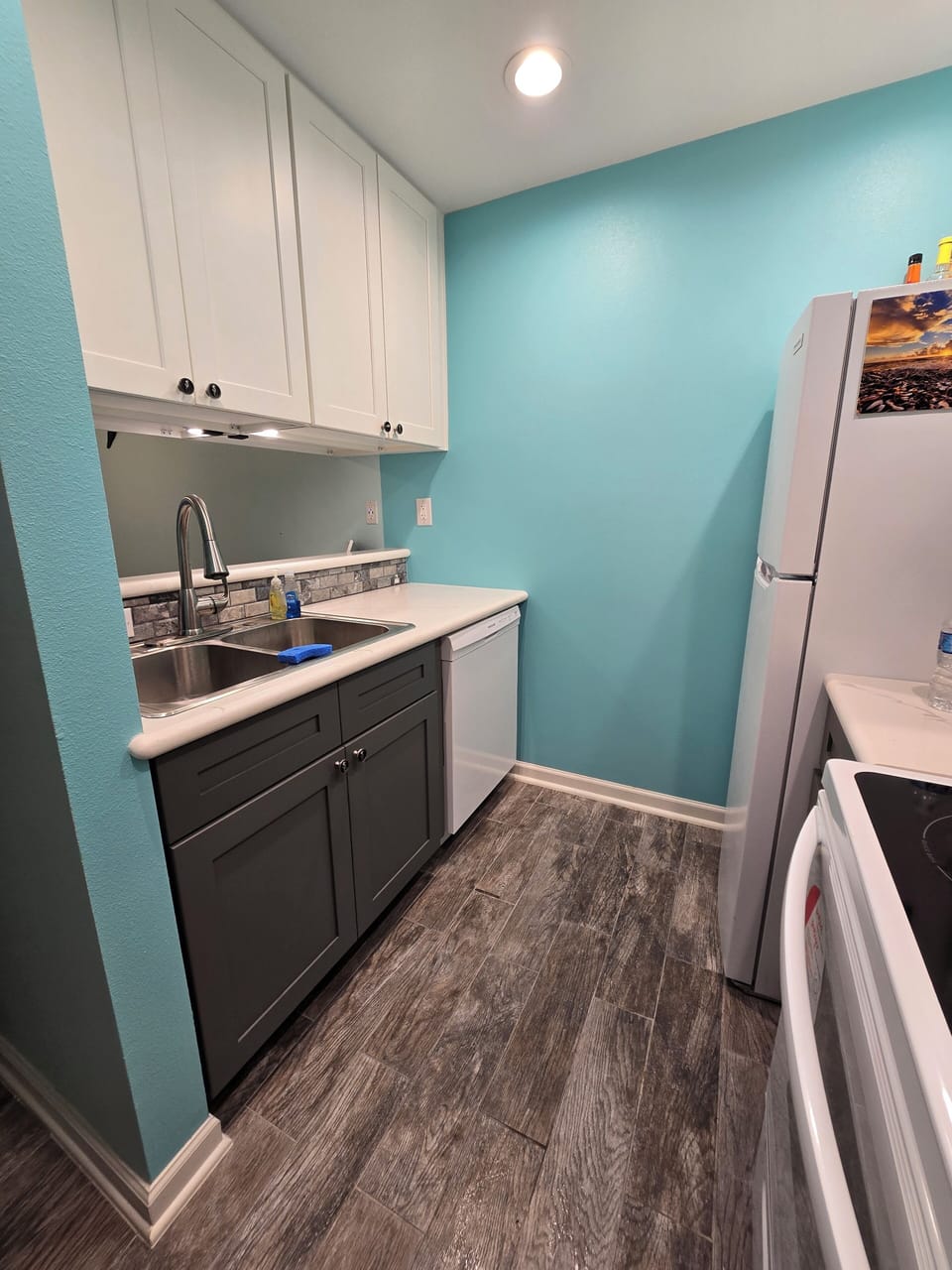 Kitchen area with disposal and dishwasher