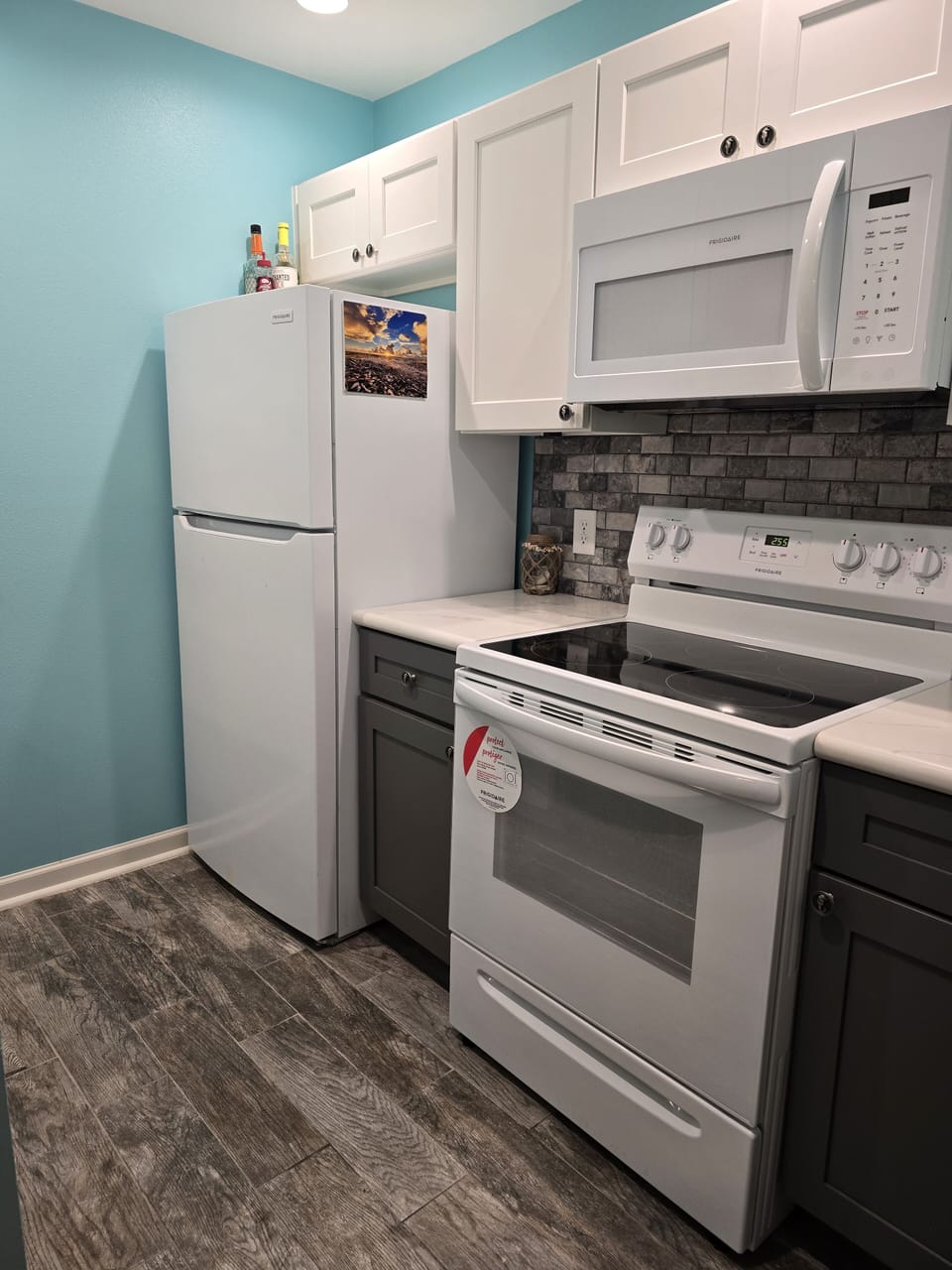 Kitchen area with glass top stove and microwave with vent-a-hood 