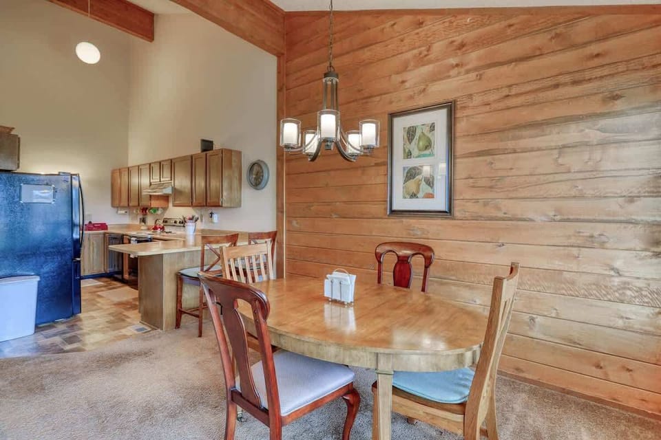 Dining table set up for 4 with bar seating for 2.  Folding chairs can be found in closet for additional dining room seating