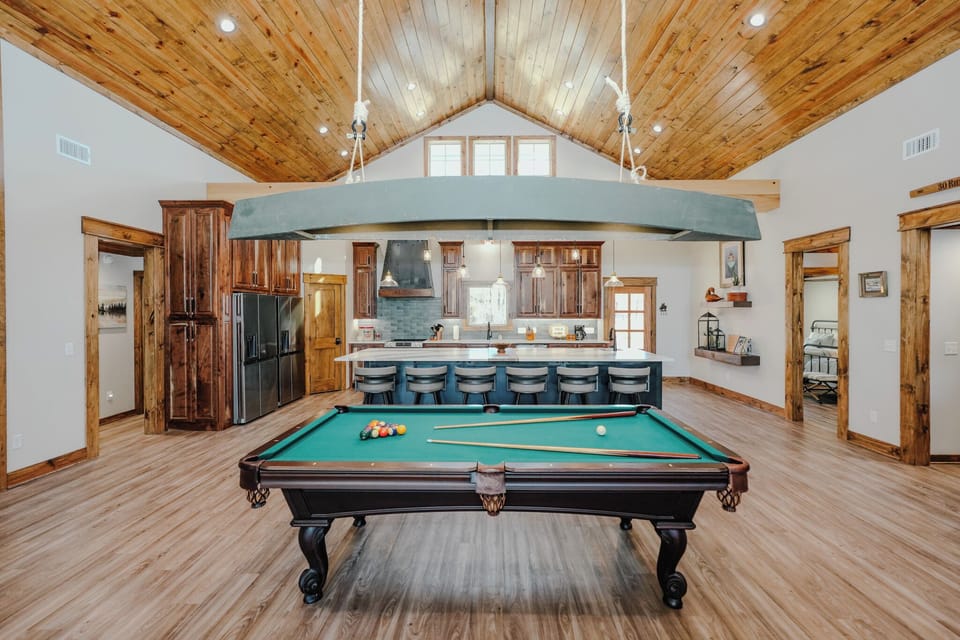 Pool table anchors the living area with clear sightlines from the kitchen.  