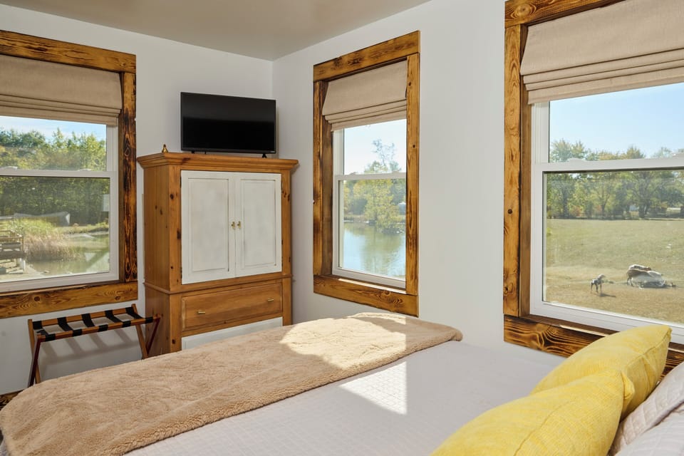 View of property, pond and animals from bedroom