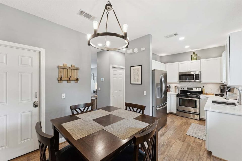 Cook, dine, and connect in this open-concept kitchen and dining area.